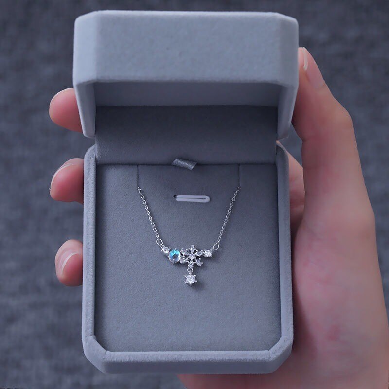 Aurora Snowflake Necklace, shown on a plain background