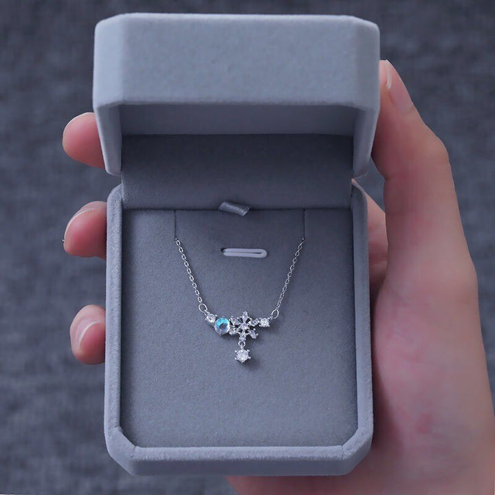 Aurora Snowflake Necklace, shown on a plain background
