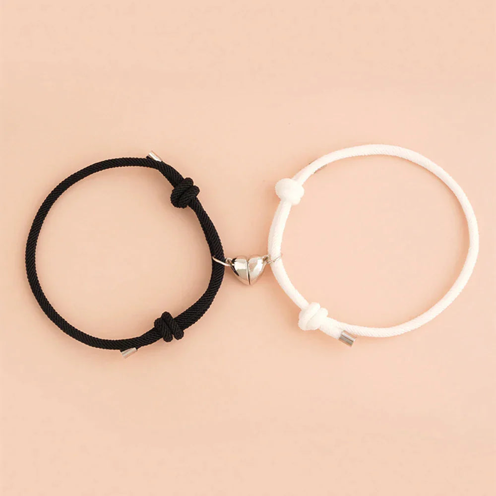 Magnetic Heart Bracelets in black and white on a soft peach background