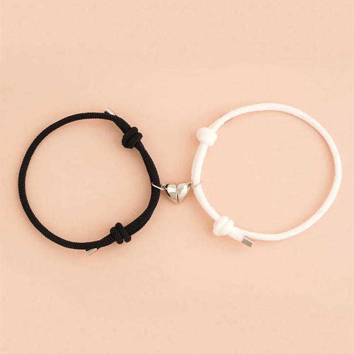 Magnetic Heart Bracelets in black and white on a soft peach background