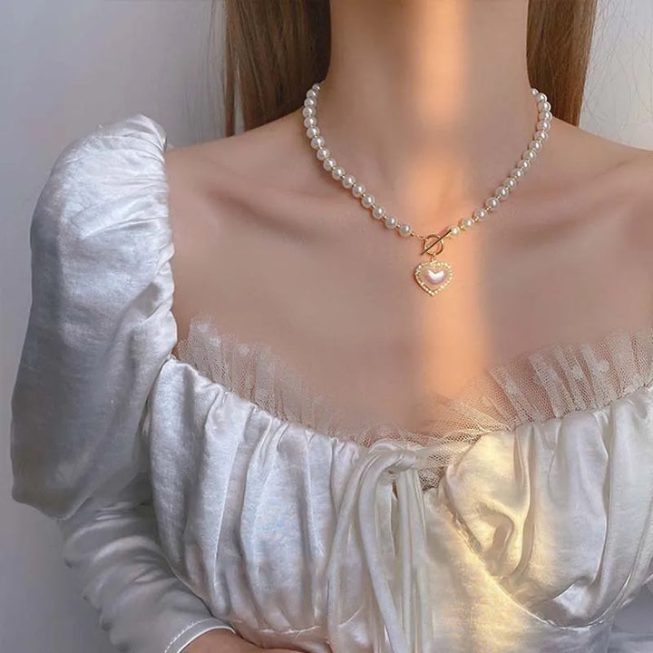 Heart Pearl Necklace, worn at the neckline
