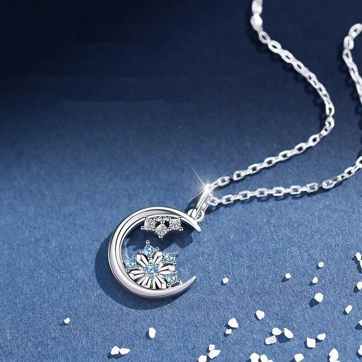 Moon Snowflake Necklace, shown on a plain background