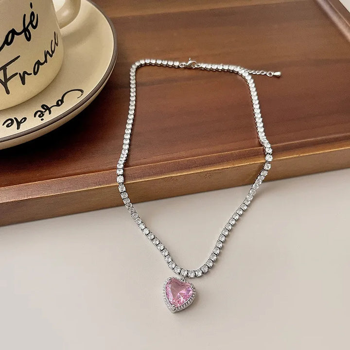 Pink Crystal Heart Pendant, worn at the neckline