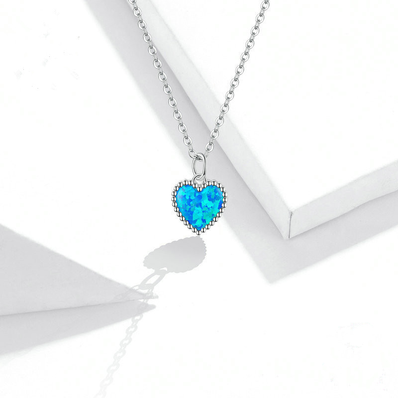 Deep Blue Heart Necklace, shown on a plain background
