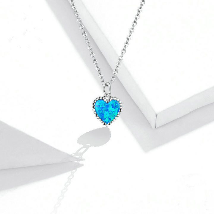 Deep Blue Heart Necklace, shown on a plain background