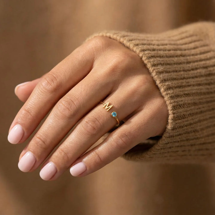 Bond Adjustable Initial and Birthstone Ring in gold, styled on the hand