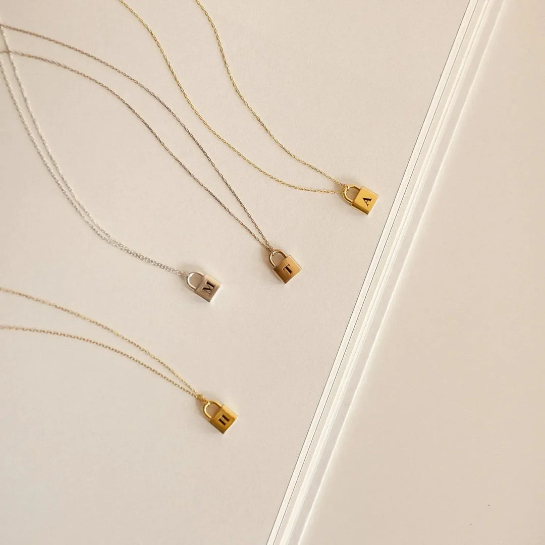 Lucy Initial Necklace in gold, close-up while worn