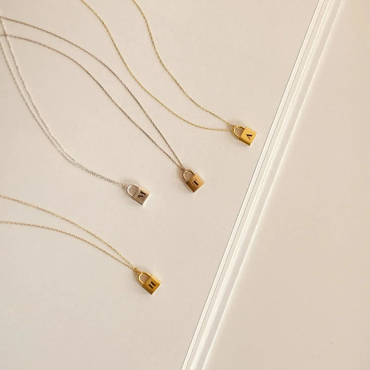 Lucy Initial Necklace in gold, close-up while worn