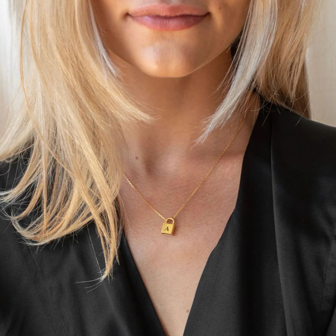 Lucy Initial Necklace in gold, styled on the model