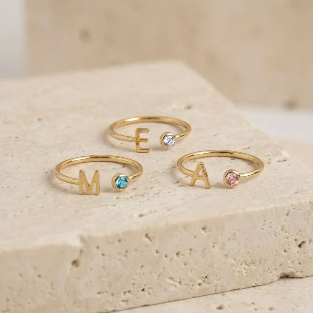 Bond Adjustable Initial and Birthstone Ring in gold, close-up on the finger