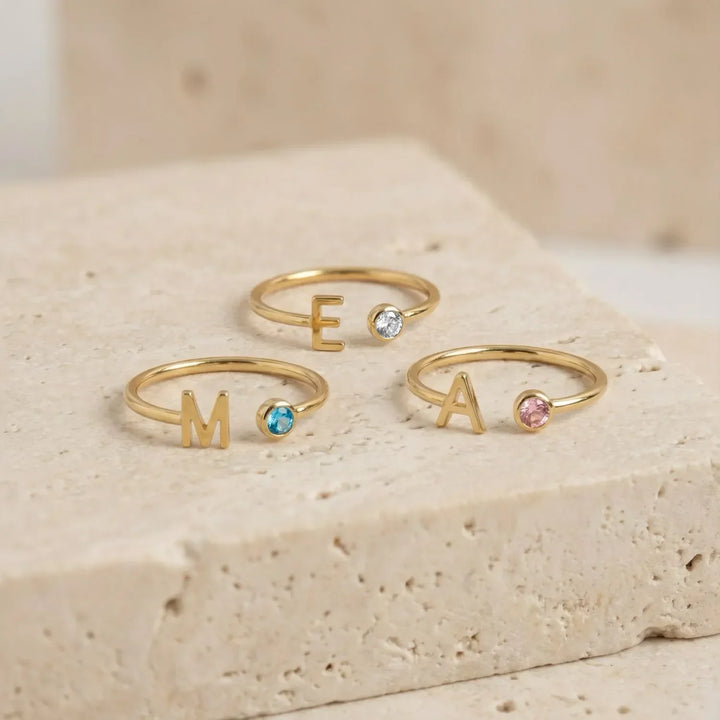 Bond Adjustable Initial and Birthstone Ring in gold, close-up on the finger