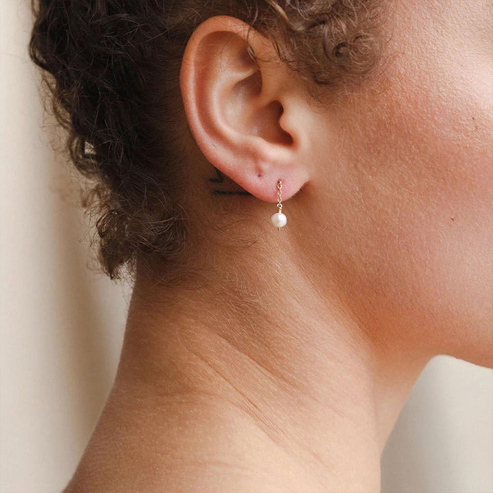 Eliz Pearl Drop Earrings, worn on the ear