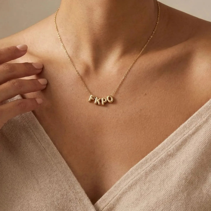 Lovia Balloon Letter Necklace, worn at the neckline