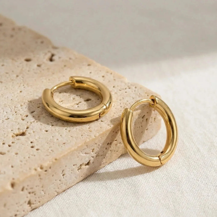 Abia Stud Earrings, styled on the model
