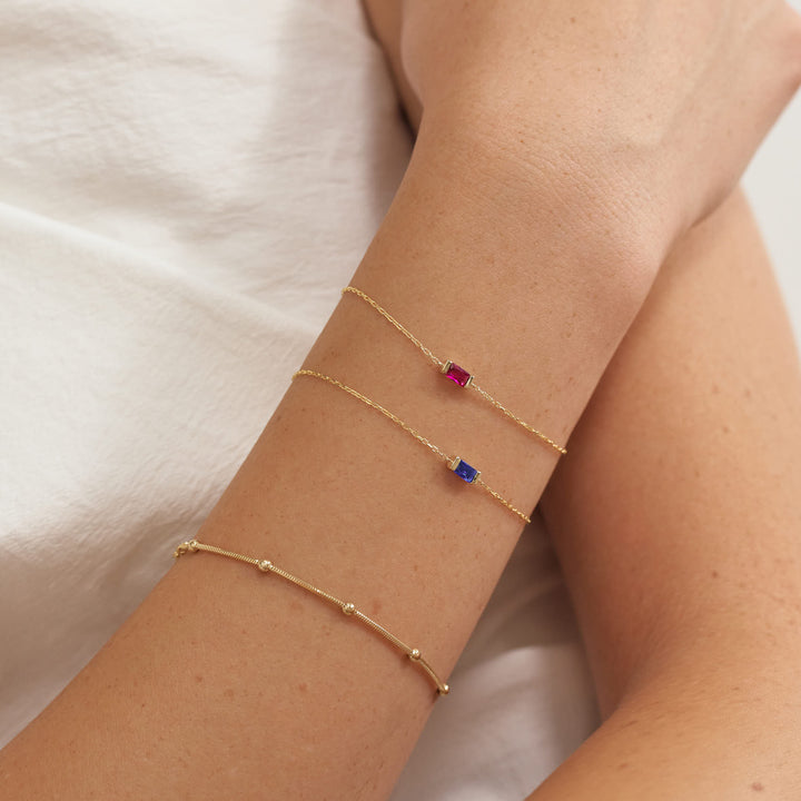 Birthstone Bracelet in gold, shown on the model