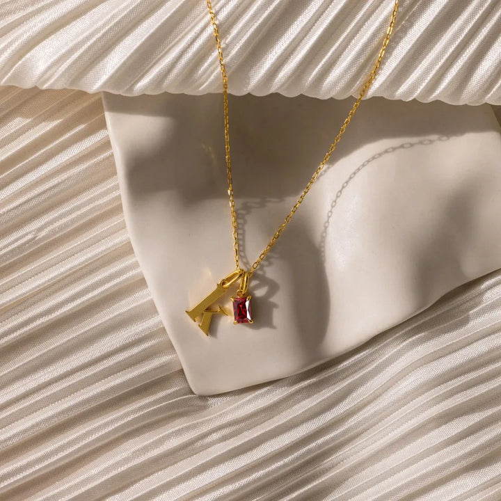 Signature Birthstone Necklace in gold, shown on the model