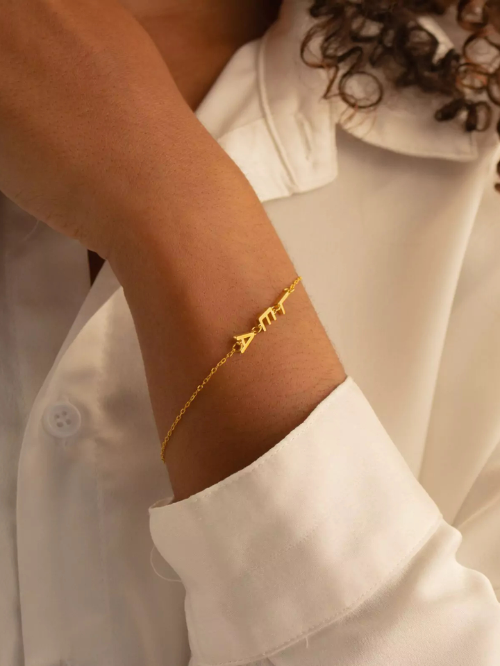 Golden Bond Name Bracelet, worn on the wrist