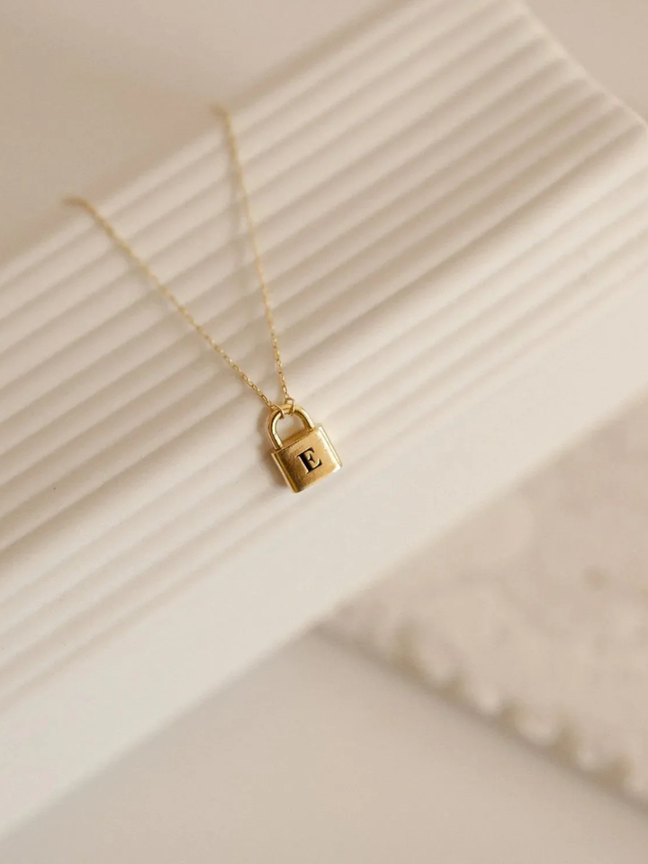 Lucy Initial Necklace in gold, worn at the neckline