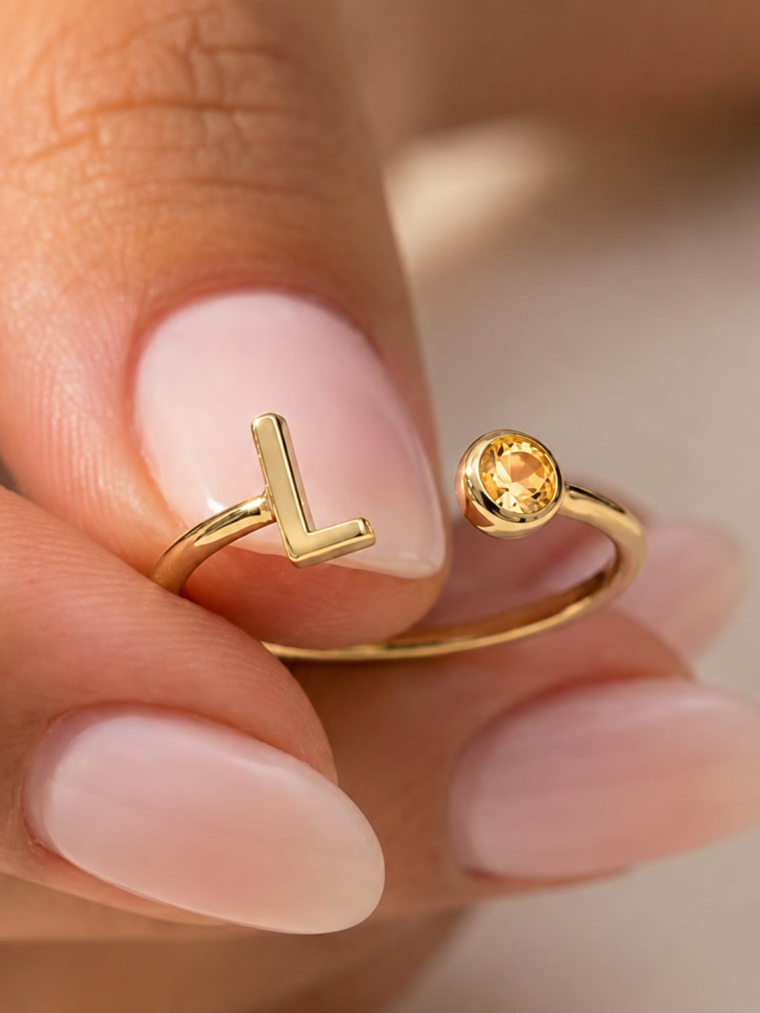 Bond Adjustable Initial and Birthstone Ring in gold, worn on the hand