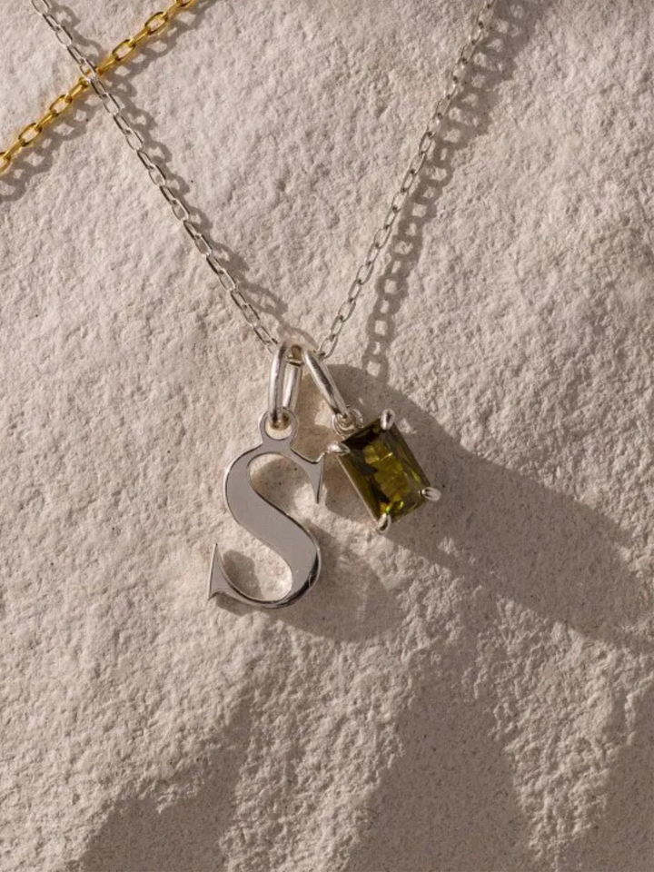 Initial and Birthstone Necklace in silver, worn at the neckline