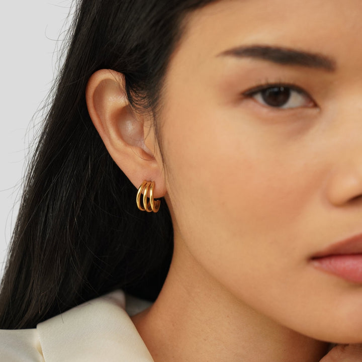 Rani Earrings in gold, styled on the model