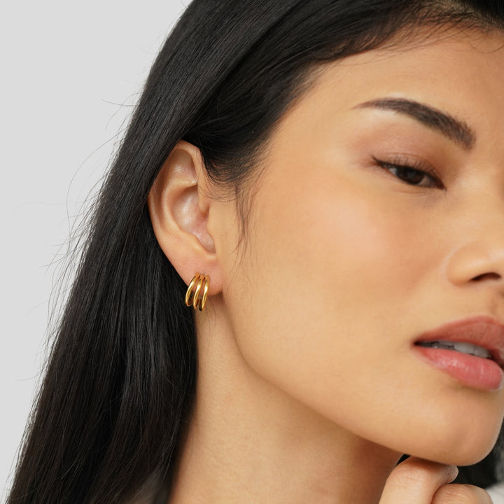 Rani Earrings in gold, worn on the ear