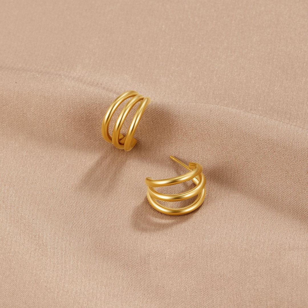 Rani Earrings in gold, shown on the model
