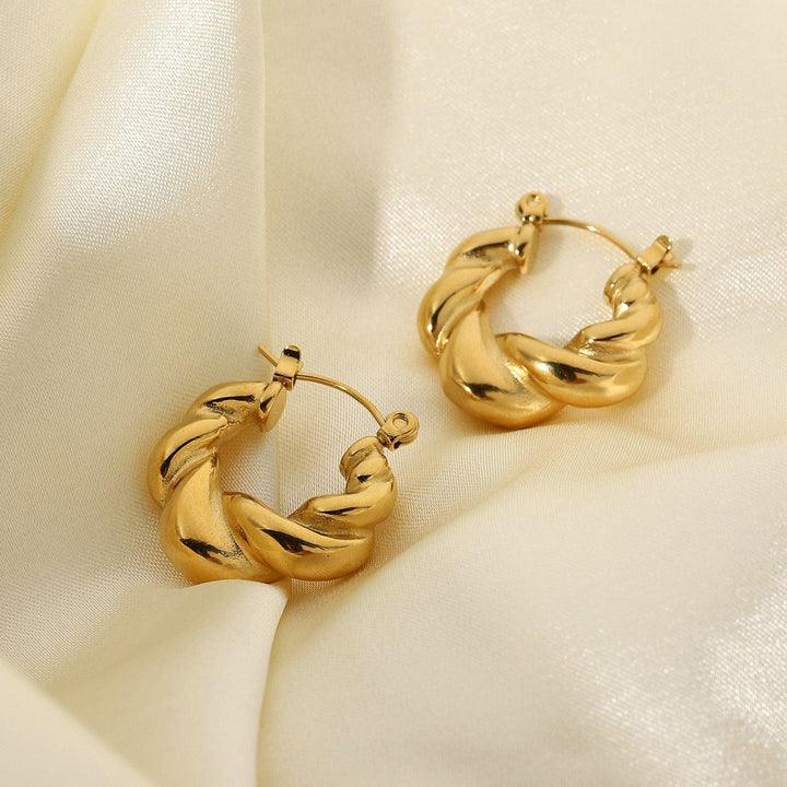 Alana Braided Earrings in gold, close-up on the ear