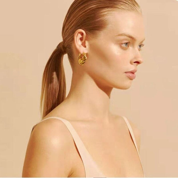 Alana Braided Earrings in gold, worn on the ear